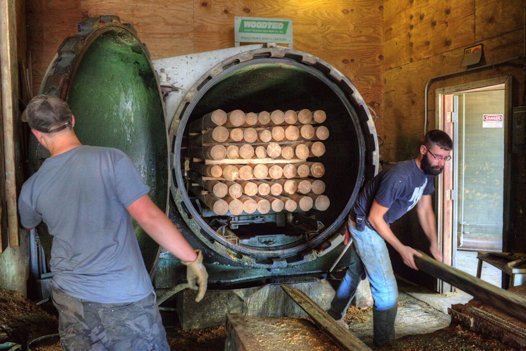 Bundles of posts being loaded into the pressure cooker