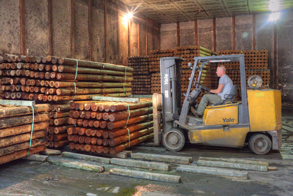 Treated posts being stacked